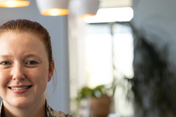 Smiling woman in medical clinic, focusing on work and enjoying environment, copy space