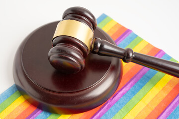 Gavel on rainbow flag for judge lawyer, symbol of LGBT pride month.