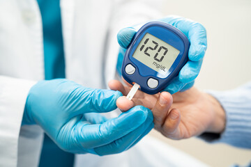 Doctor use digital glucose monitor measure and test stripe for check diabetes from finger blood...