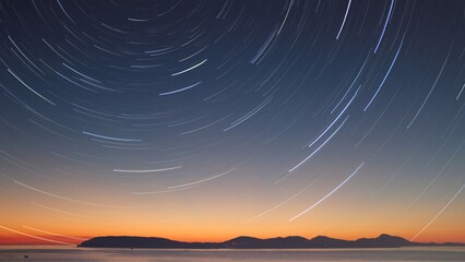 the mesmerizing beauty of the night sky, filled with swirling star trails that create a sense of movement and wonder
