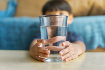 kid holding glass of water for dringking, healthy lifestyle concept