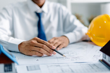 Architect working with house plans on a blueprint in the office, .development low residence projects, design home custom of customer, build a housing estate.