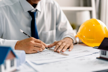 Architect working with house plans on a blueprint in the office, .development low residence projects, design home custom of customer, build a housing estate.