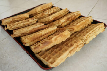 Homemade Waffles, delicious, close up. Waffle is a dish made from leavened batter or dough that is cooked between two plates that are patterned to give a characteristic size, shape, and surface impres