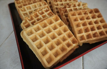 Homemade Waffles, delicious, close up. Waffle is a dish made from leavened batter or dough that is cooked between two plates that are patterned to give a characteristic size, shape, and surface impres