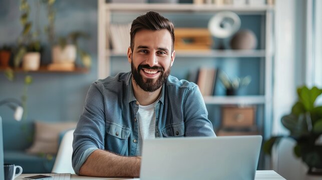 Smiling graphic designer in office, working on laptop and graphics tablet for designs