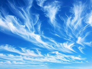 1. Wispy high-altitude clouds spread across a deep blue sky, appearing as delicate brush strokes, moving gently in horizontal bands contrasting each other