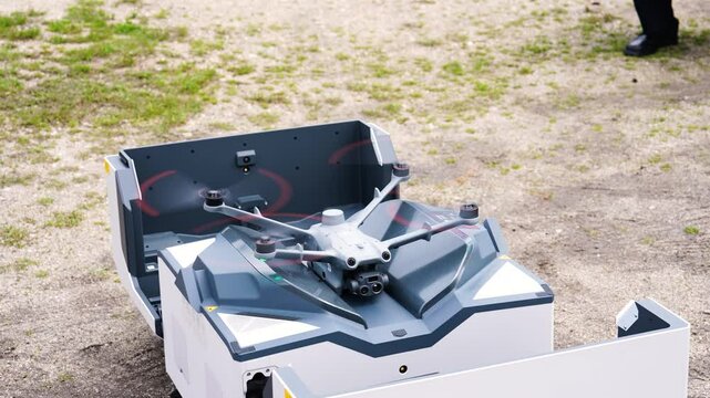 Automated aerial surveillance drone ready to take off from dock station