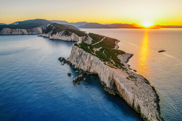 Lighthouse on the cliff. Seascape of Cape Lefkatas with old lighthouse on Lefkada island, Greece....