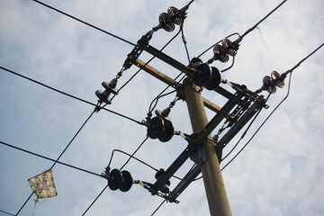 Electric poles and kites on wires