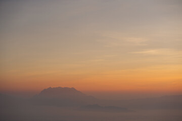 travel and people activity concept with twilight sky before sunrise with mountain and fog on foreground