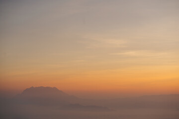 travel and people activity concept with twilight sky before sunrise with mountain and fog on foreground