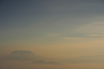 travel and people activity concept with twilight sky before sunrise with mountain and fog on foreground