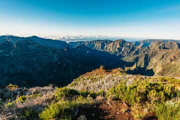 Hiking on the highest peak of Madeira Pico Ruivo next to the cottage Abrigo do Pico Ruivo. Views of...