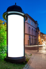 Mockup Of Advertising Poster Classic Style Lightbox At Night. Round Vertical Ad Billboard On The Old Town Street