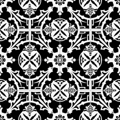  A seamless pattern of vintage black and white tiles with intricate geometric and floral designs, featuring circular motifs with cross-like symbols and symmetrical leaf-like elements.