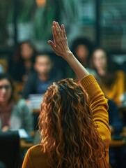 A woman holding up her hand in front of a gathering of people, possibly asking for attention or making a statement