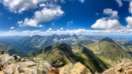 Mountain panorama bathed in sunshine, expansive view from a high perspective, highlighting the majestic peaks and valleys