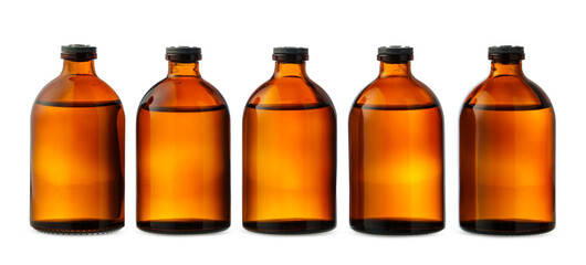 Five Amber Glass Bottles With Liquid on White Background