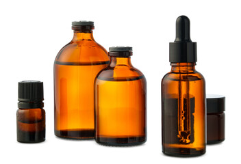 Amber Glass Bottles of Essential Oils and Cream Isolated on White Background