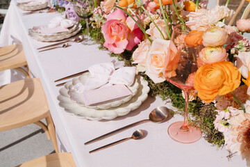 Vibrant florals and colorful place setting on wedding table
