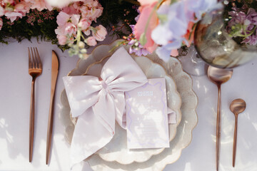 Vibrant florals and colorful place setting on wedding table