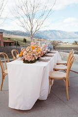 Vineyard wedding table with vibrant floral arrangements