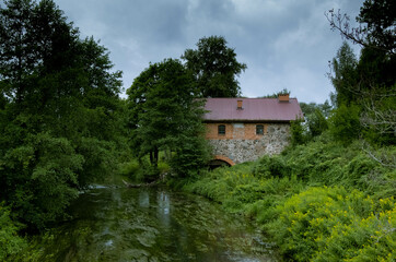 Old brick mill with a view on river in Mazury Poland