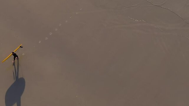 Above View Of A Person With Surfing Board Walking