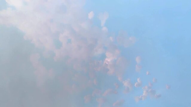 Large number of fireworks exploding at once in the blue sky during the day with thunderous sound. Mascleta in Fallas event in Valencia, Spain