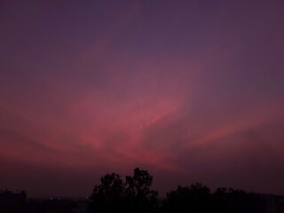 time lapse of clouds at night, sunset scenery view of red sky background,  silhouette of trees and buildings, nature photography