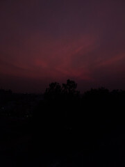 time lapse of clouds at night, sunset scenery view of red sky background,  silhouette of trees and buildings, nature photography