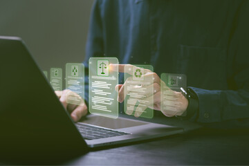 Businessman uses computer and pokes finger on law scale logo with global environmental law icon....