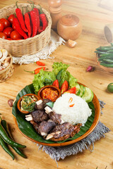rice food and side dishes as well as fresh vegetables, and typical Indonesian chili sauce