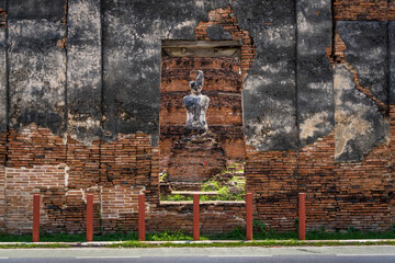 Ayutthaya, Thailand - May 10, 2024 :Buddha statue in ancient Thai temple at Wat Si Sanphet, Ayutthaya, showcasing historic Buddhist architecture amidst cultural ruins