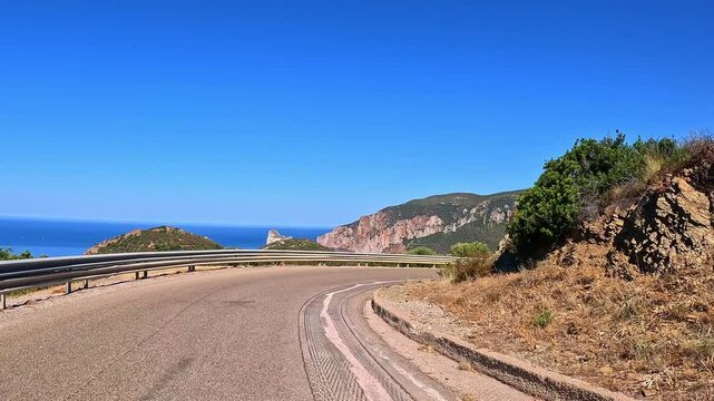 Highway travelling, point of view, Sardinian picturesque coastline