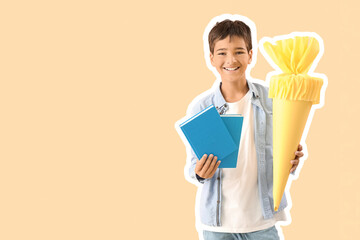 Little boy with yellow school cone and books on beige background