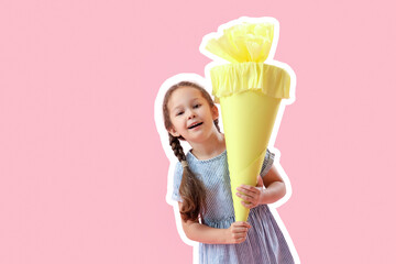 Happy little girl with yellow school cone on pink background