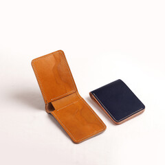 various leather wallets in various colors and cartoon cases with plain white backgrounds