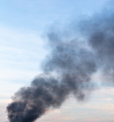 Black smoke from a fire against the sky