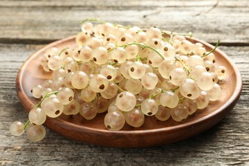 Fresh white currant berries on wooden table, closeup