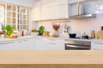 Kitchen wood table top for product display with blurred modern interior. Wooden tabletop over defocused kitchen background. kitchen furniture and desk space. product promotion in the kitchen