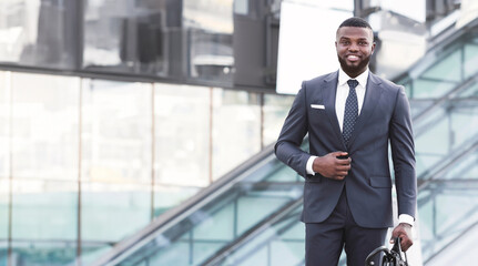 Successful African Businessman Going On Business Meeting Holding Briefcase Walking In Urban Area In City. Vertical, Full Length