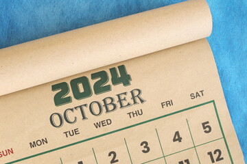 October 2024 calendar flat lay in blue background with copy space.
