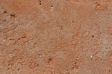 Background texture of wall with coarse stucco or concrete in warm brown colour in Italy