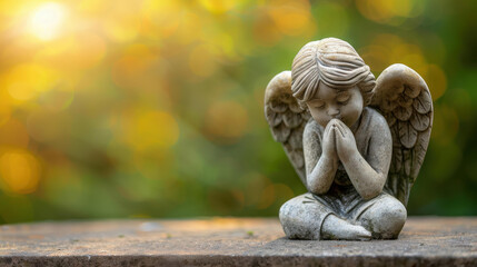Angel statue at cemetery with copy space for text, ideal for funeral concept visuals.