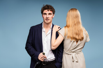 Businessman covered with kisses holding champagne with girlfriend