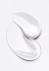 samples of cosmetic care products smear of cream and gel texture on a light background