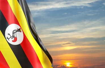 Uganda flag against the sunset. National Holidays concept