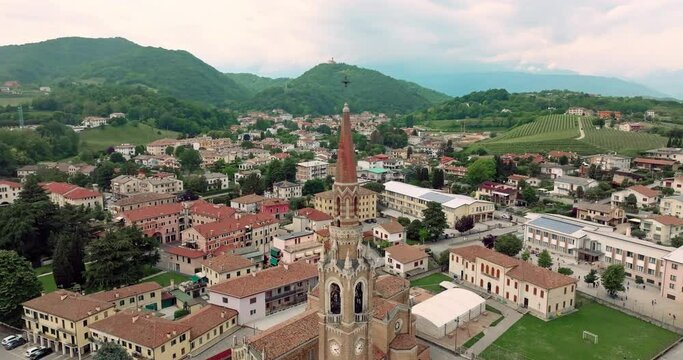 Exploring Cornuda from Above: Aerial Cityscape View of Cathedral Architecture and Bell Tower. High quality 4k footage